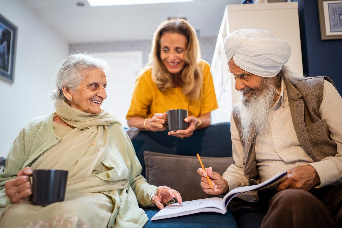A group of older adults gathered together in a bright community space